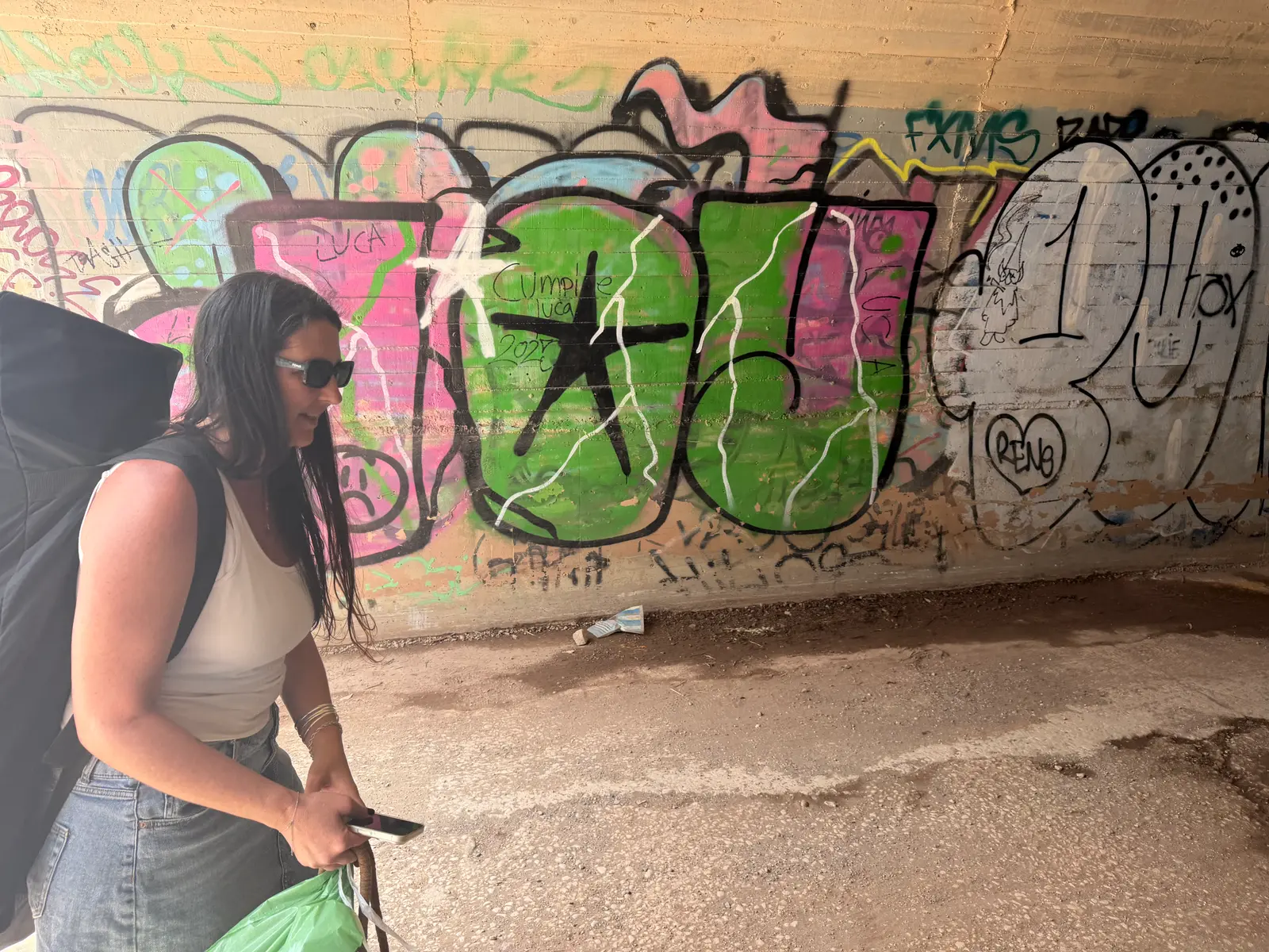 Heidi walking past graffiti in the tunnel on the way to Playa Peñón del Cuervo