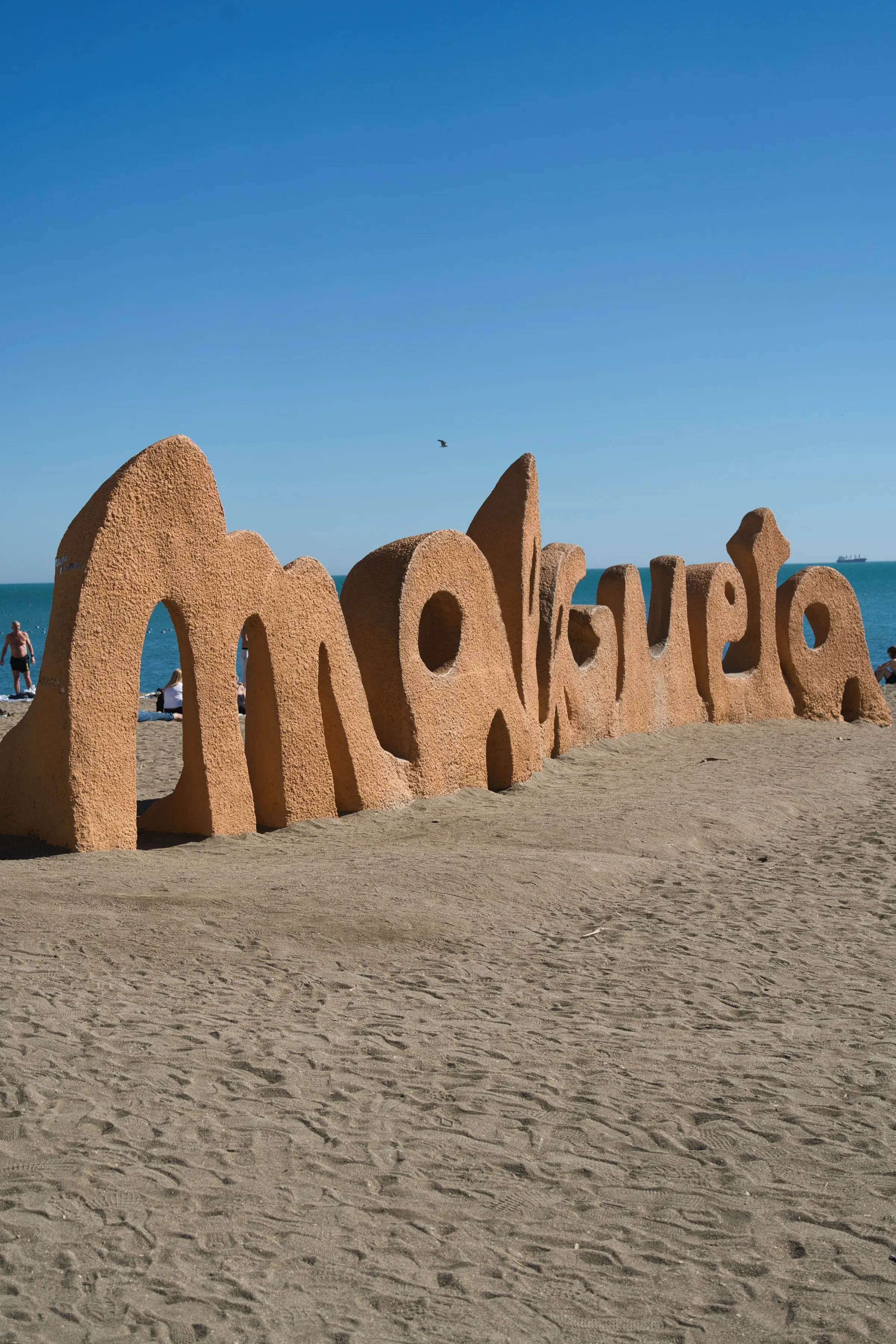 The Malagueta sign sculpture on the sand at Playa Malagueta with blue sky