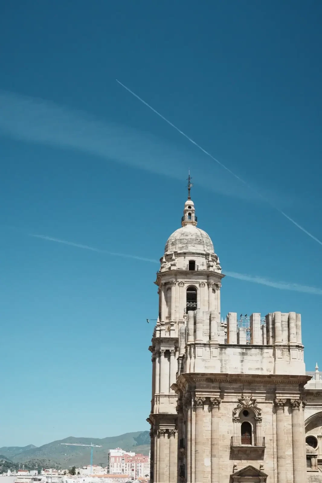 Málaga Cathedral rising against a blue sky, one tower unfinished