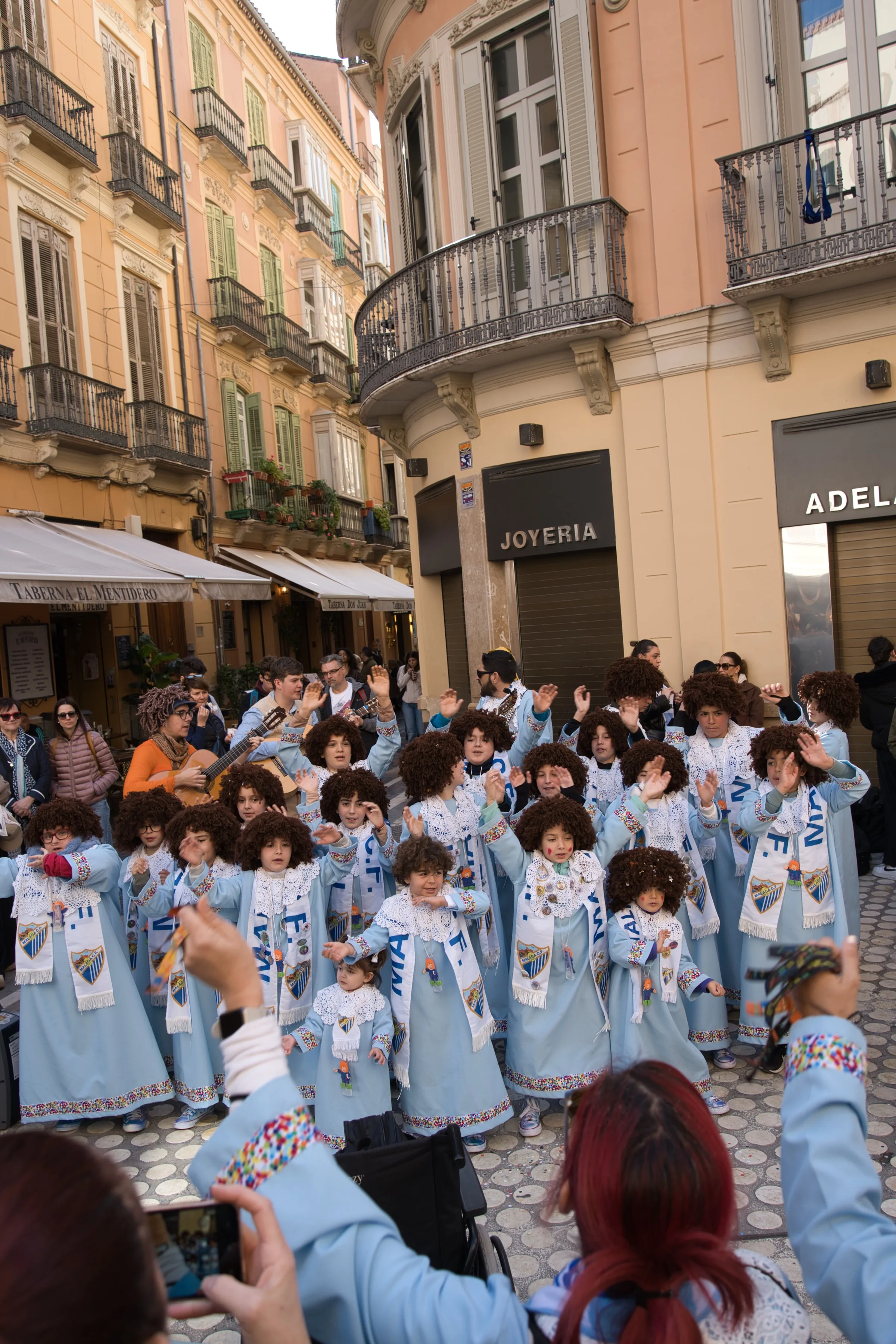 Children in costume singing at Málaga Carnival