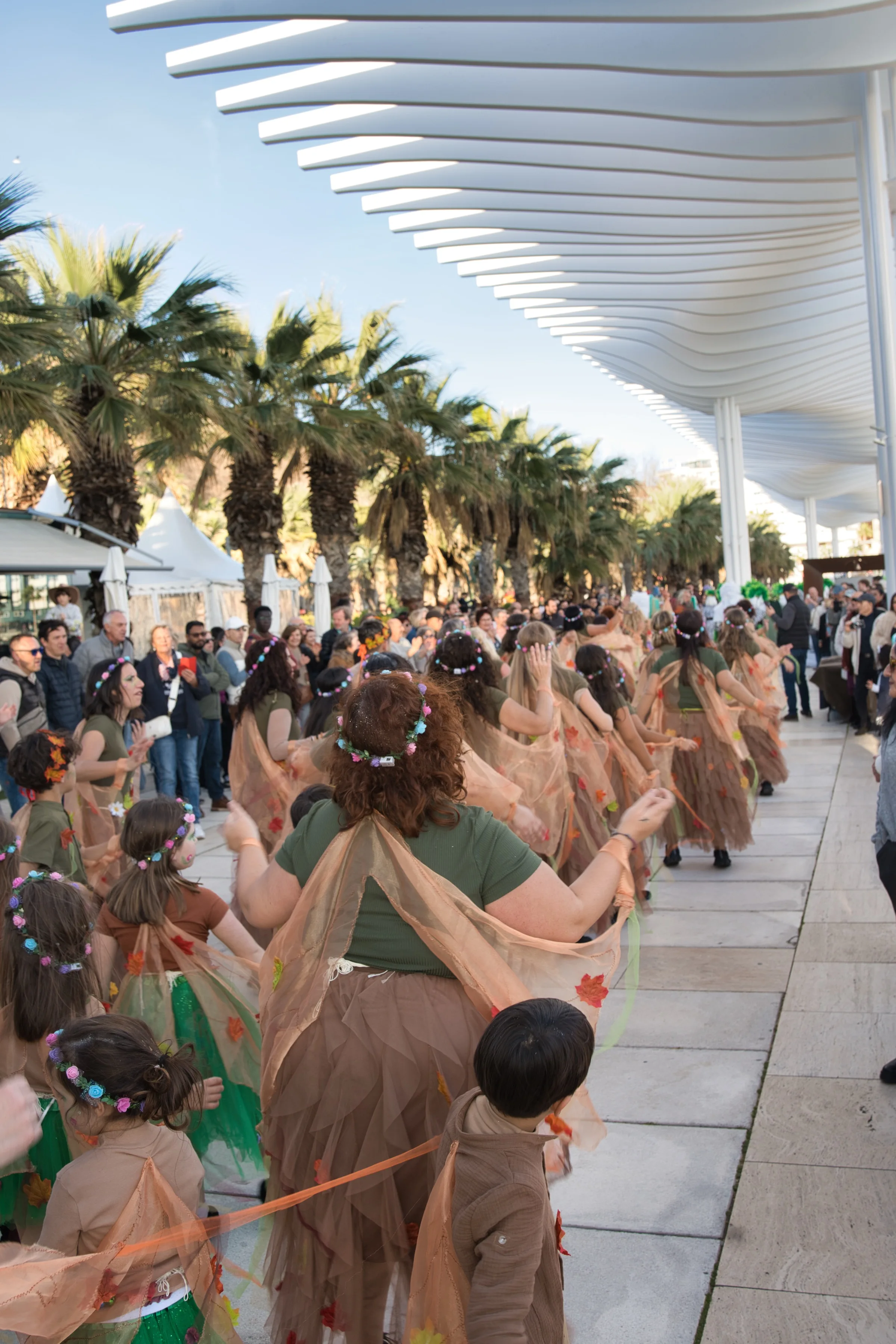 Women in costume clapping during the Malaga Carnival celebrations