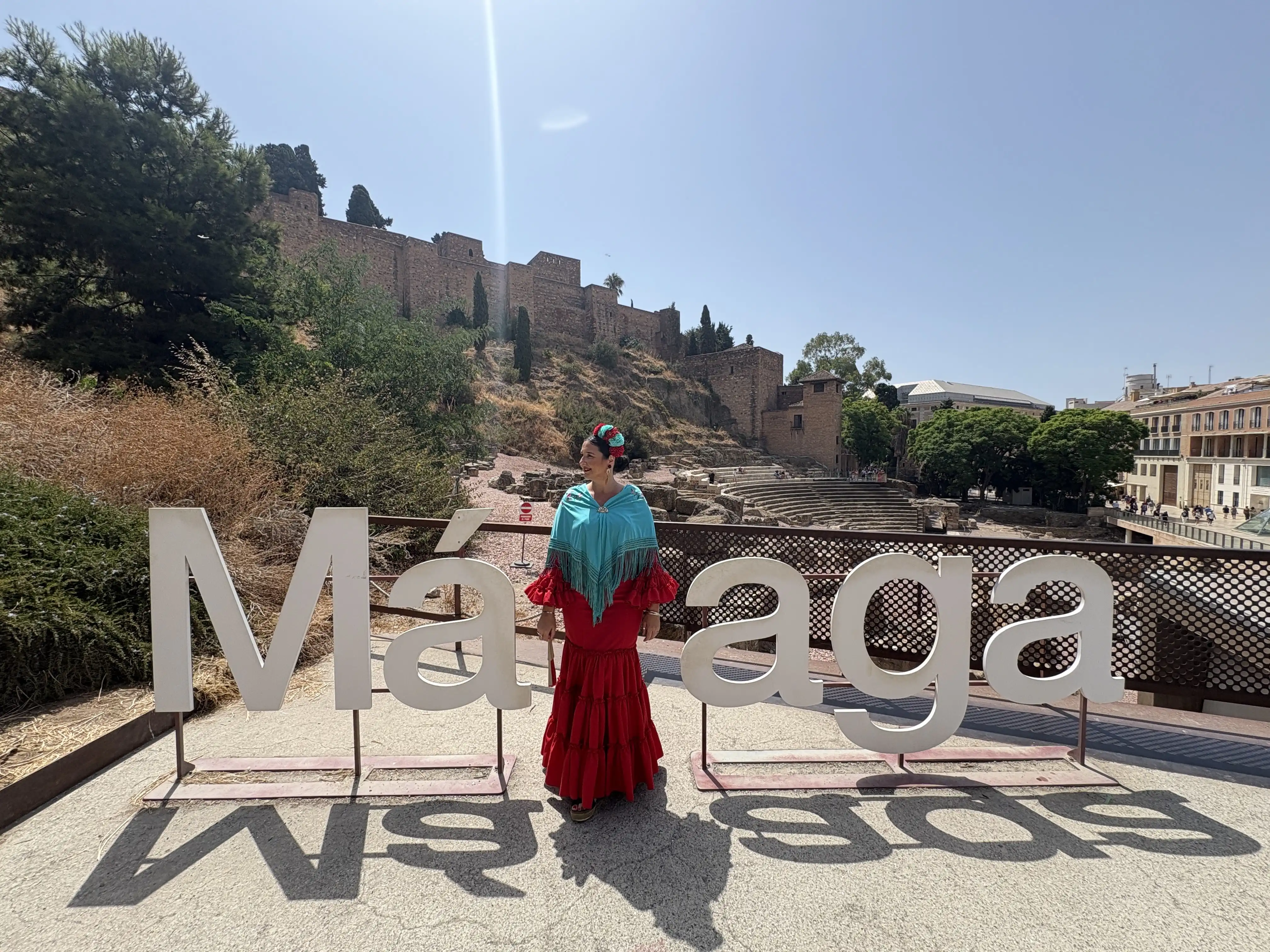 Woman posing at the Málaga sign during the August summer feria