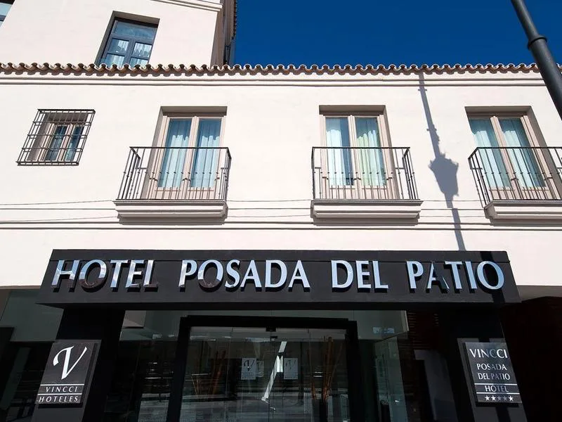 Vincci Seleccion Posada del Patio hotel entrance sign on a Malaga old town street