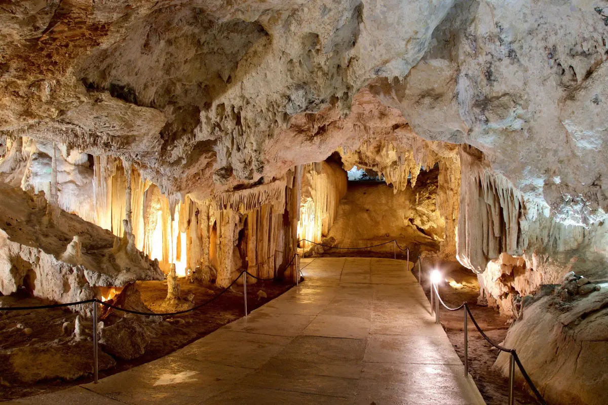 The lit walkway winding through the stalactites of the Nerja Caves
