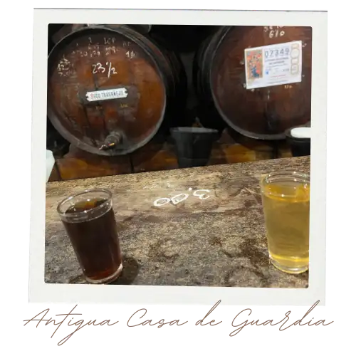 Bar counter at Antigua Casa de Guardia with chalk tallies and small wine glasses