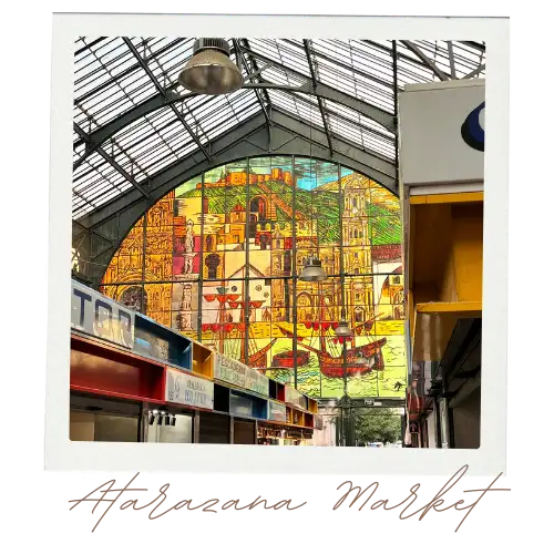 Stained glass wall inside Atarazanas market Málaga depicting boats horses and fields