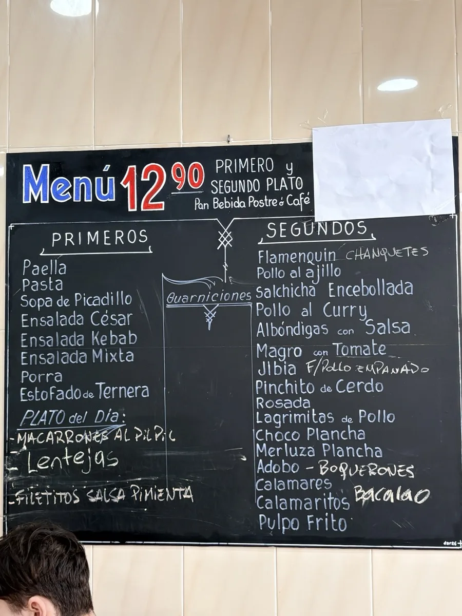 The menú board at Bar La Merced in Málaga, listing primeros, segundos and a plato del día for €12.90