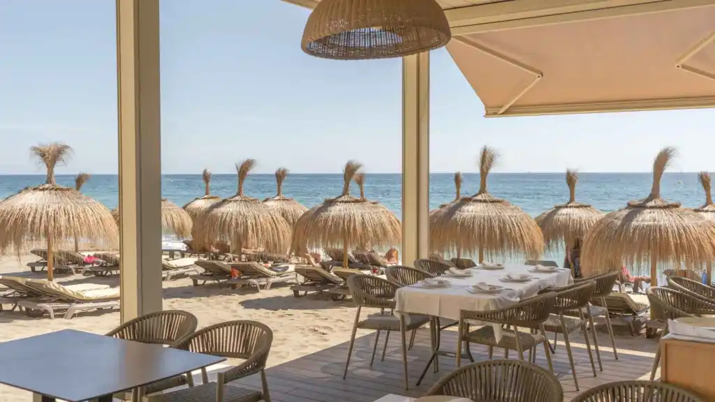 Malaga beach loungers and straw umbrellas from a resturant in Malaga