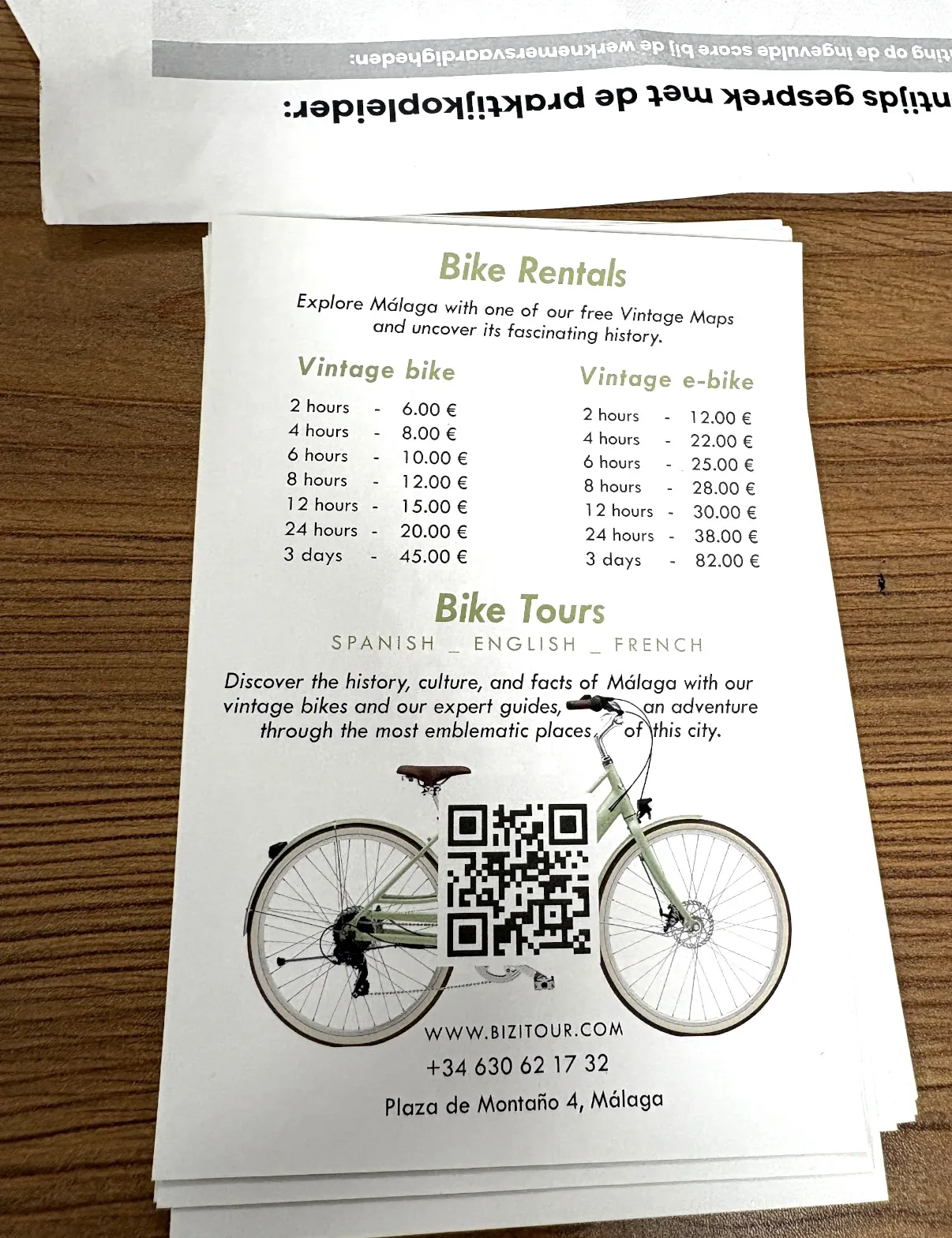 The Bizi Tour leaflet listing bike rental prices and tours, with the Plaza de Montaño address