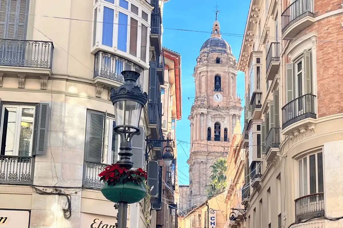 Pedestrians walking through Malaga's car-free historic centre streets