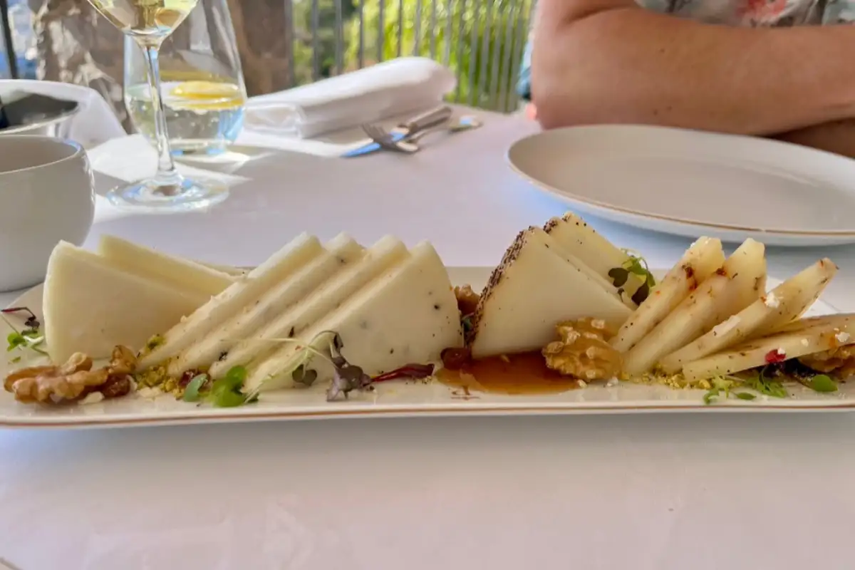 A board of local Malaga cheese with walnuts and a glass of wine