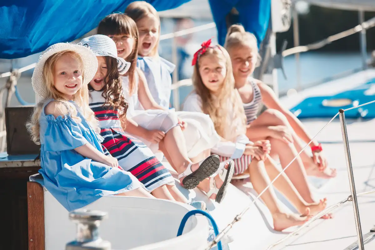 Children leaning over the side of a boat on a harbour cruise in Malaga