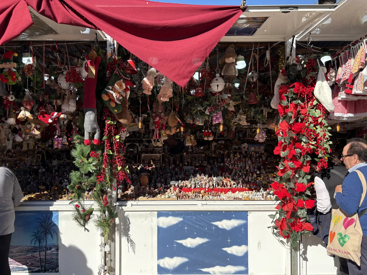 Christmas market stall packed with ornaments, stockings and nativity figurines in Malaga