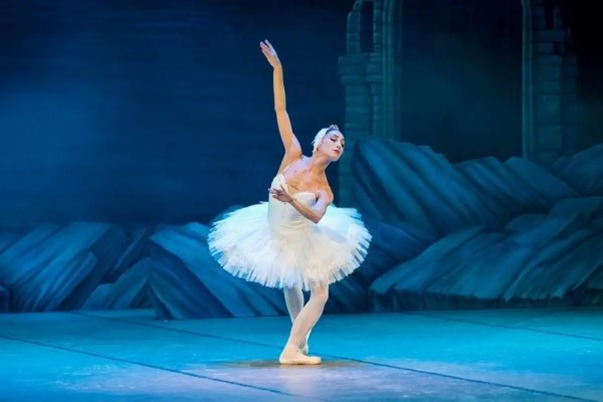 A ballerina performing Swan Lake on stage in Malaga at Christmas