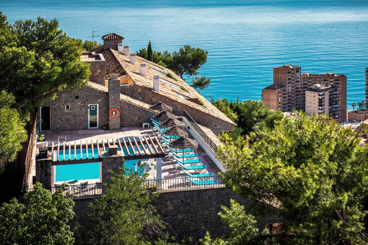 Parador de Málaga Gibralfaro pool with the Mediterranean stretching behind it