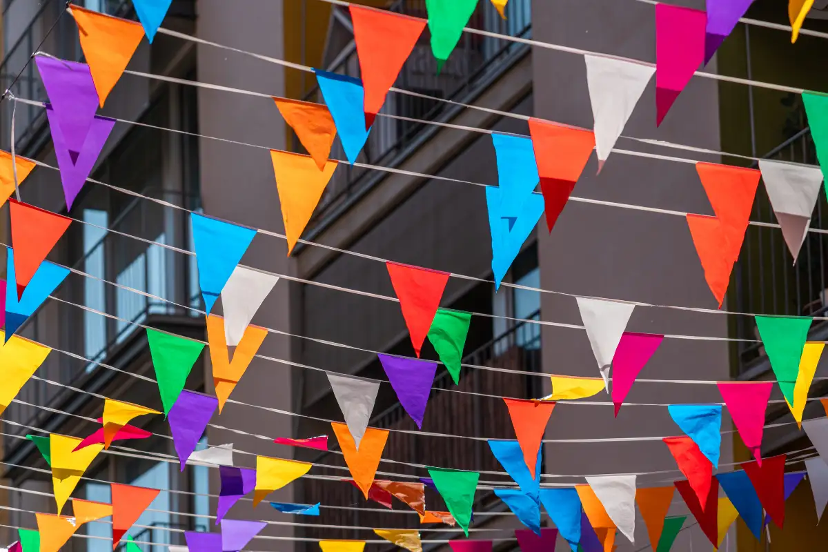 Colourful bunting and flags strung across a street in Malaga's Soho arts district