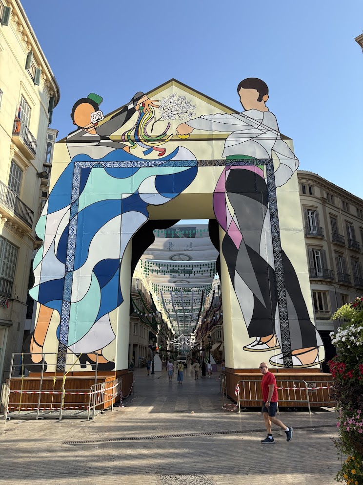 Calle Larios decorated with a painted arch during the Feria de Málaga