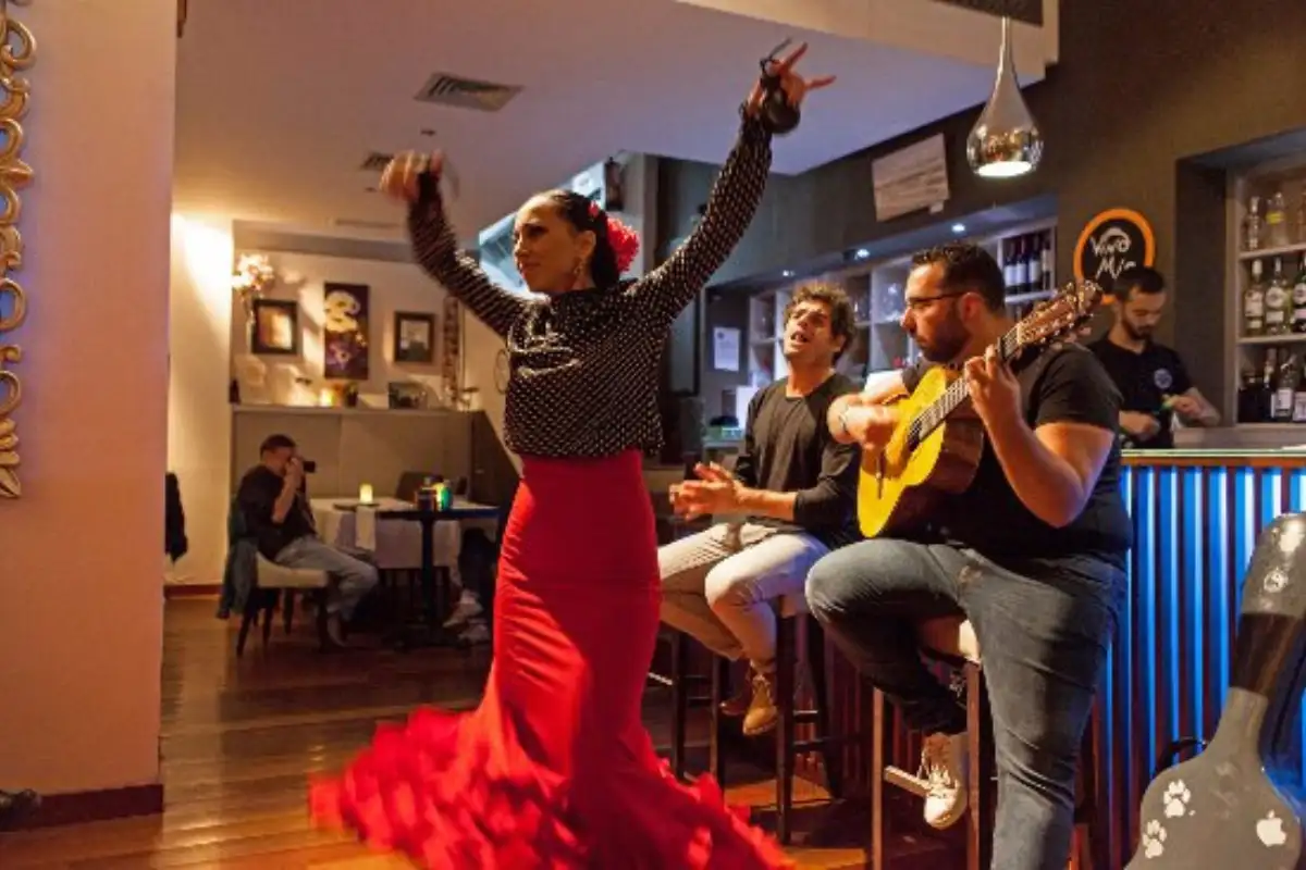 Flamenco dancer in a red dress performing with a guitarist