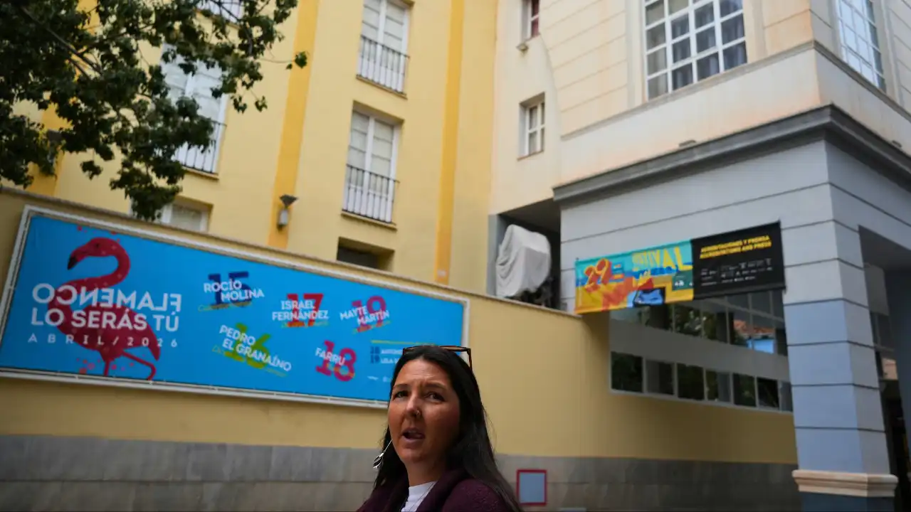 Heidi standing by a flamenco festival banner in Malaga