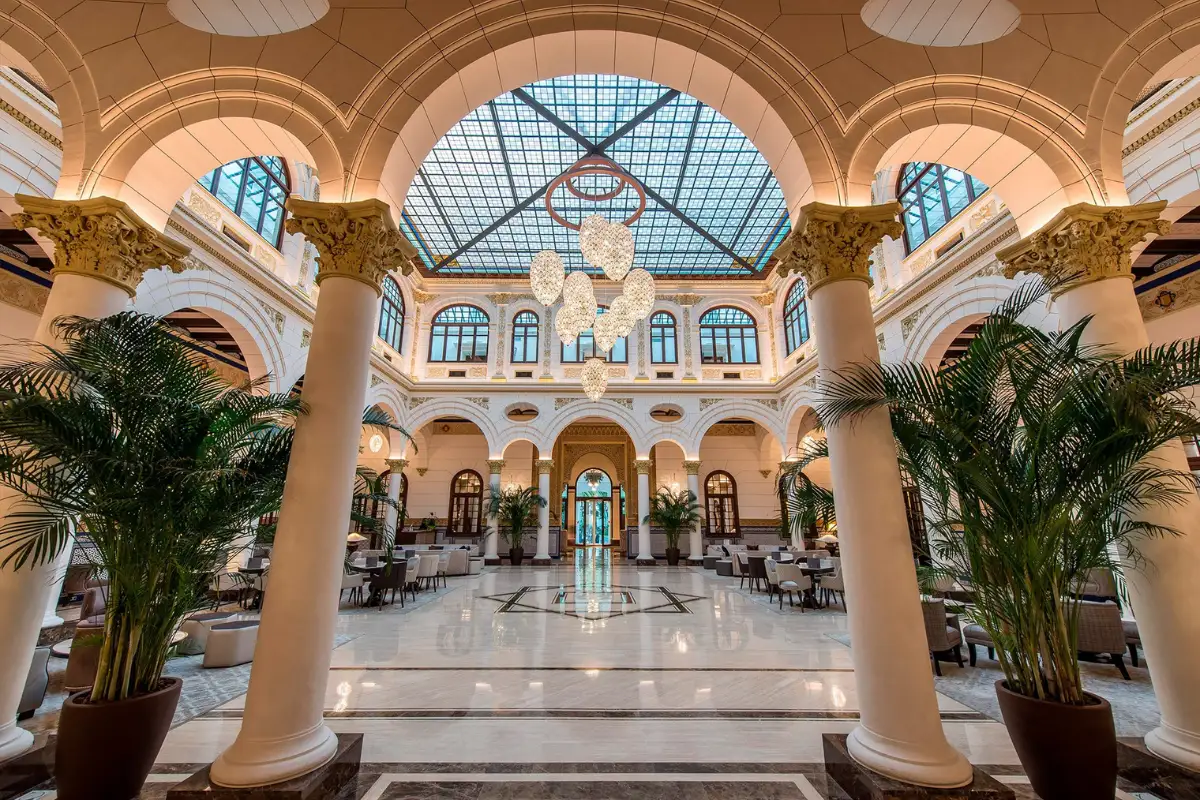Grand marble lobby with glass ceiling inside a luxury Malaga hotel
