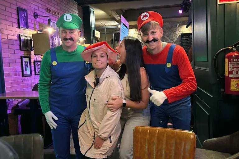 Group in Mario and Luigi Halloween costumes at a bar in Málaga