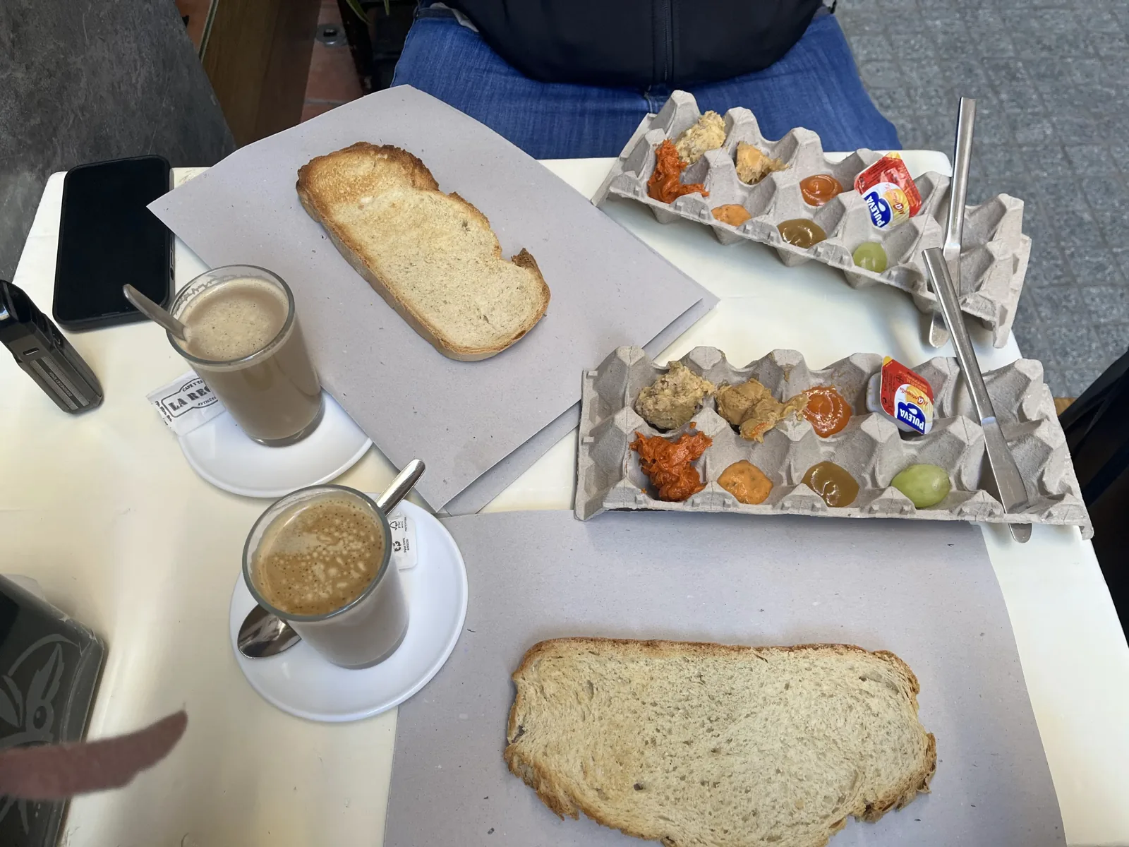 Breakfast at La Recova in Málaga, with toast and little jars of jam and pâté served in an egg carton
