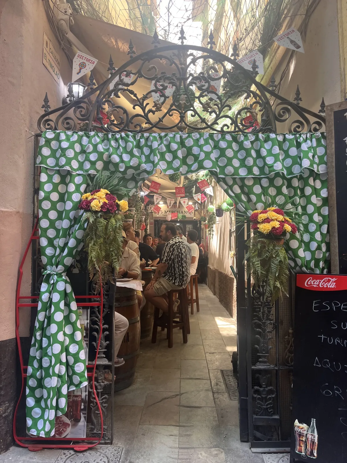 The decorated iron entrance gate of Las Merchanas tavern in Málaga's old town