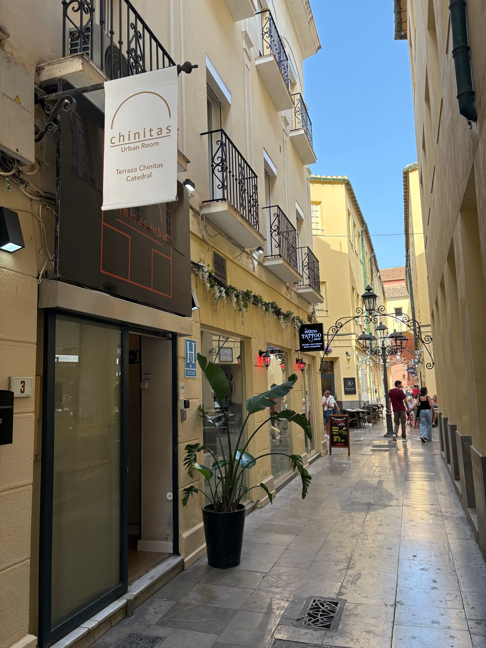 Narrow pedestrian street in Málaga's historic old town near Pasaje de Chinitas