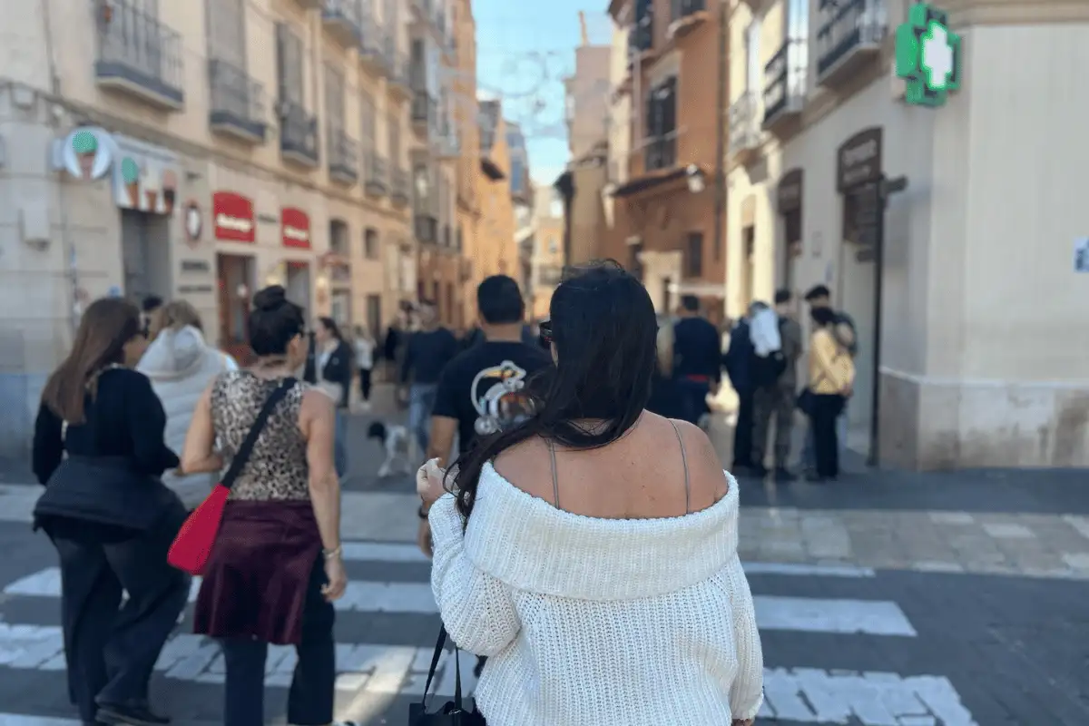 Pedestrians crossing a street in Málaga old town