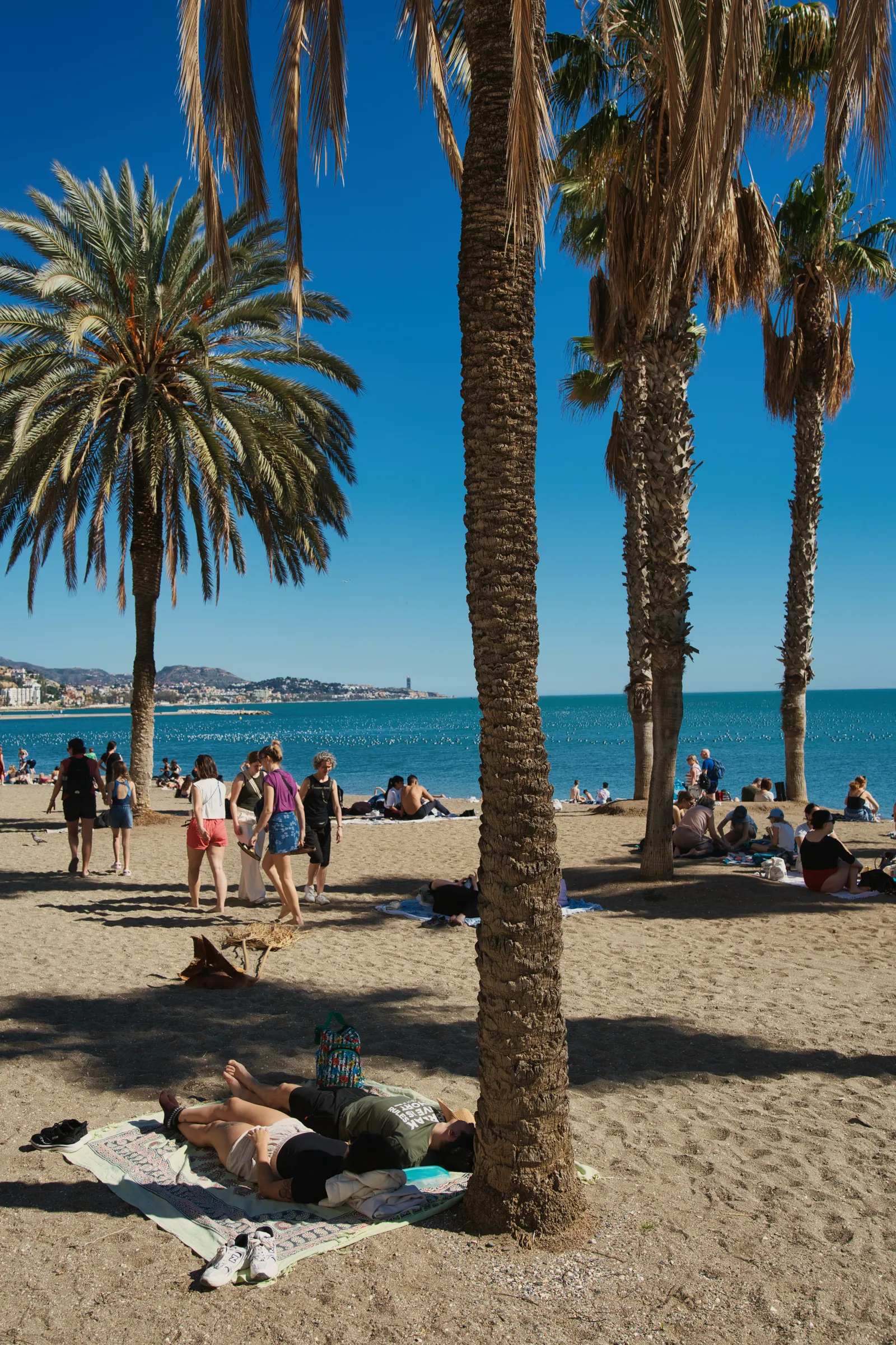 A wooden fishing boat pulled up on the sand at Playa de las Acacias in Pedregalejo, Málaga
