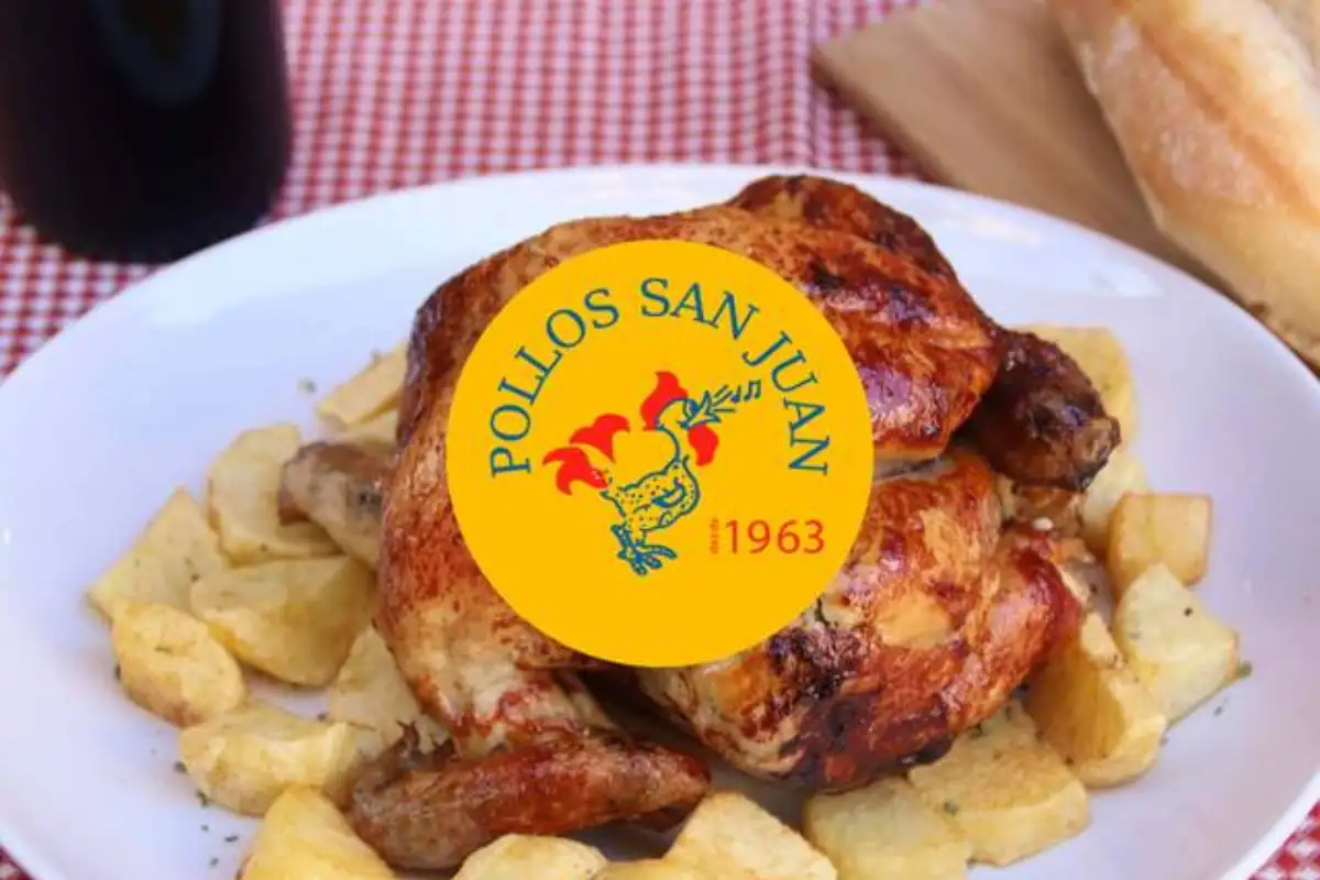 Roast chickens on a spit at a Malaga rotisserie for Noche de San Juan