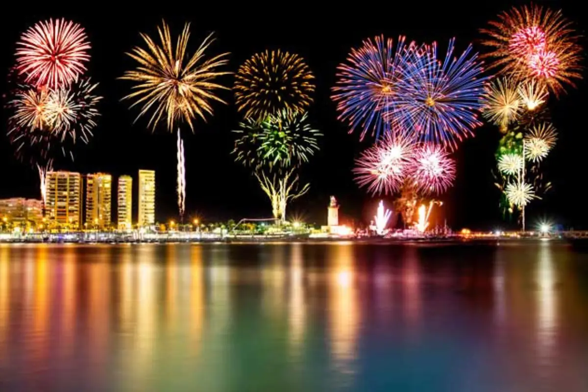 New Year's Eve fireworks bursting over Malaga's harbour at night