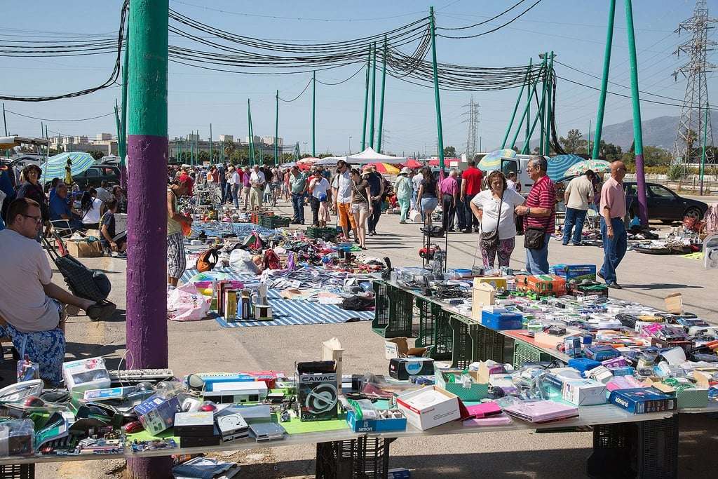Rows of stalls selling second-hand goods at the Rastro de Malaga flea market