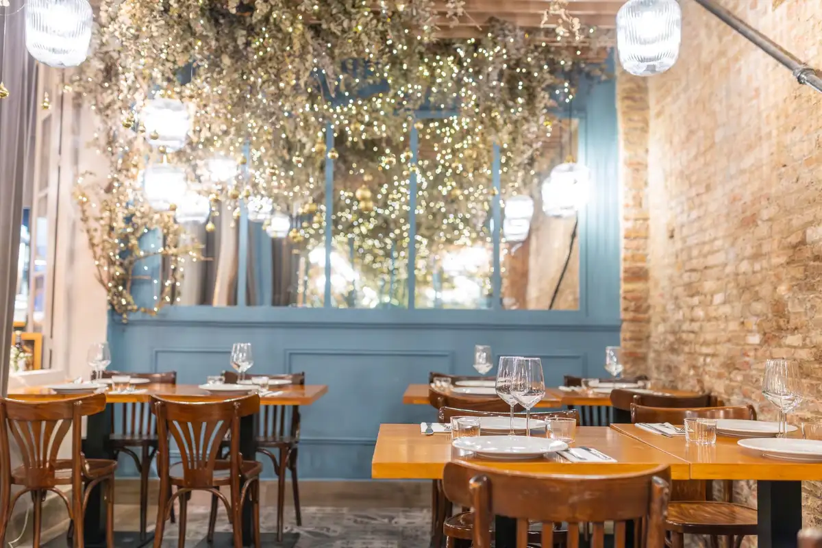 Intimate low-lit interior with wooden beams at El Meson de Cervantes Málaga