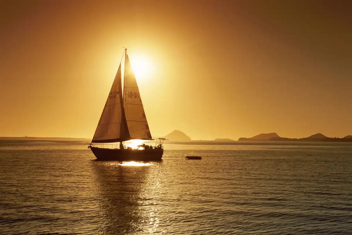 A sailboat on the sea off Málaga at sunset