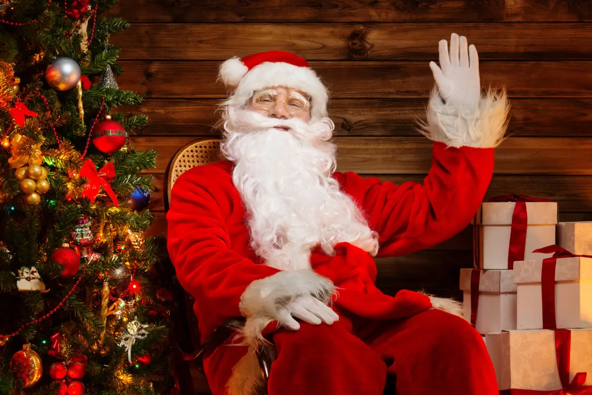 Santa Claus in a red suit waving to visitors at Muelle Uno in Malaga