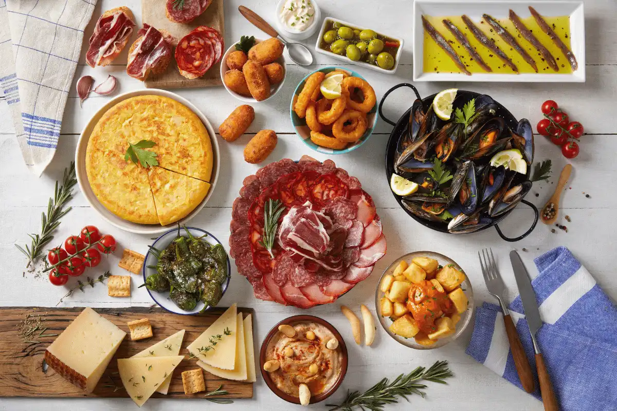 A spread of Spanish tapas dishes on a table in Málaga