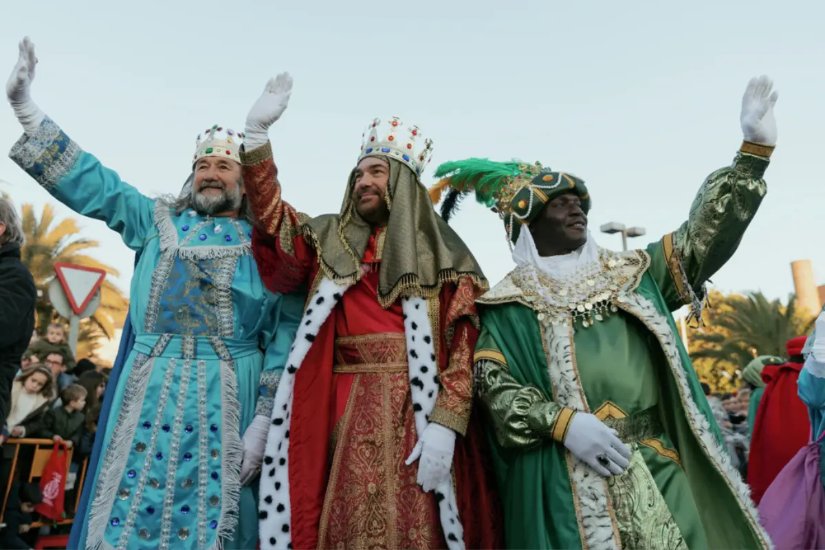 The Three Kings waving to crowds from their float during the Malaga Kings parade