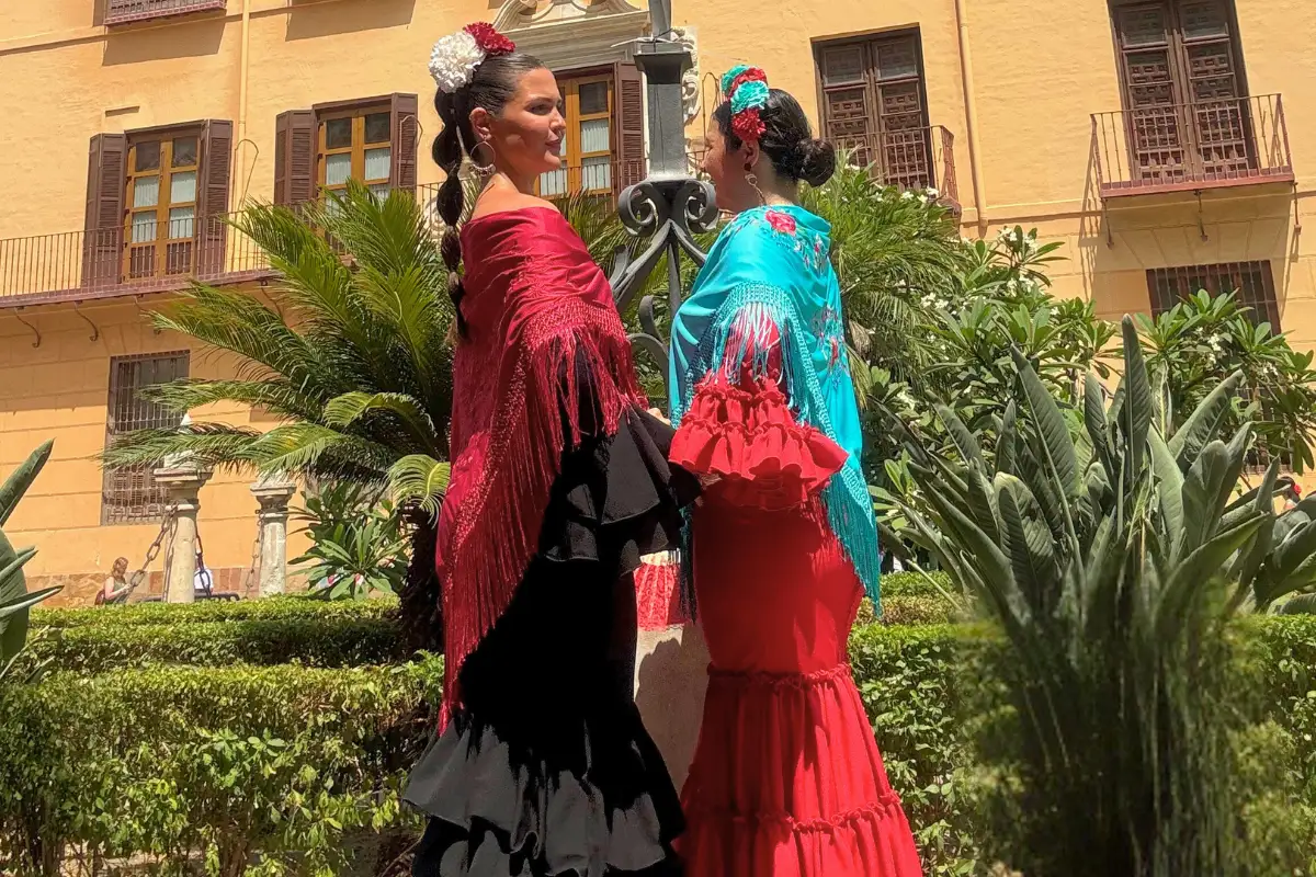 Second-hand flamenco dresses hanging on a rail in Malaga