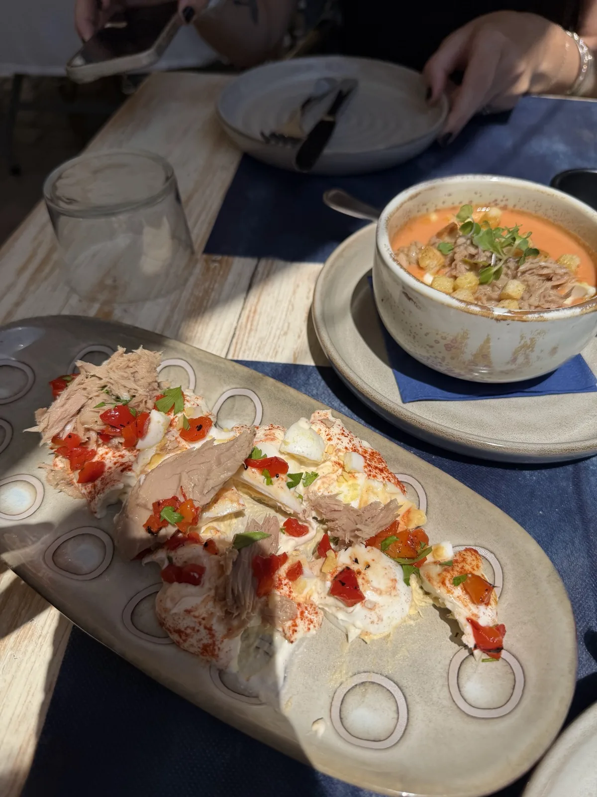 Salmorejo topped with tuna and croutons, alongside a tuna, egg and roasted pepper dish, part of the menú del día at Vino Mio in Málaga