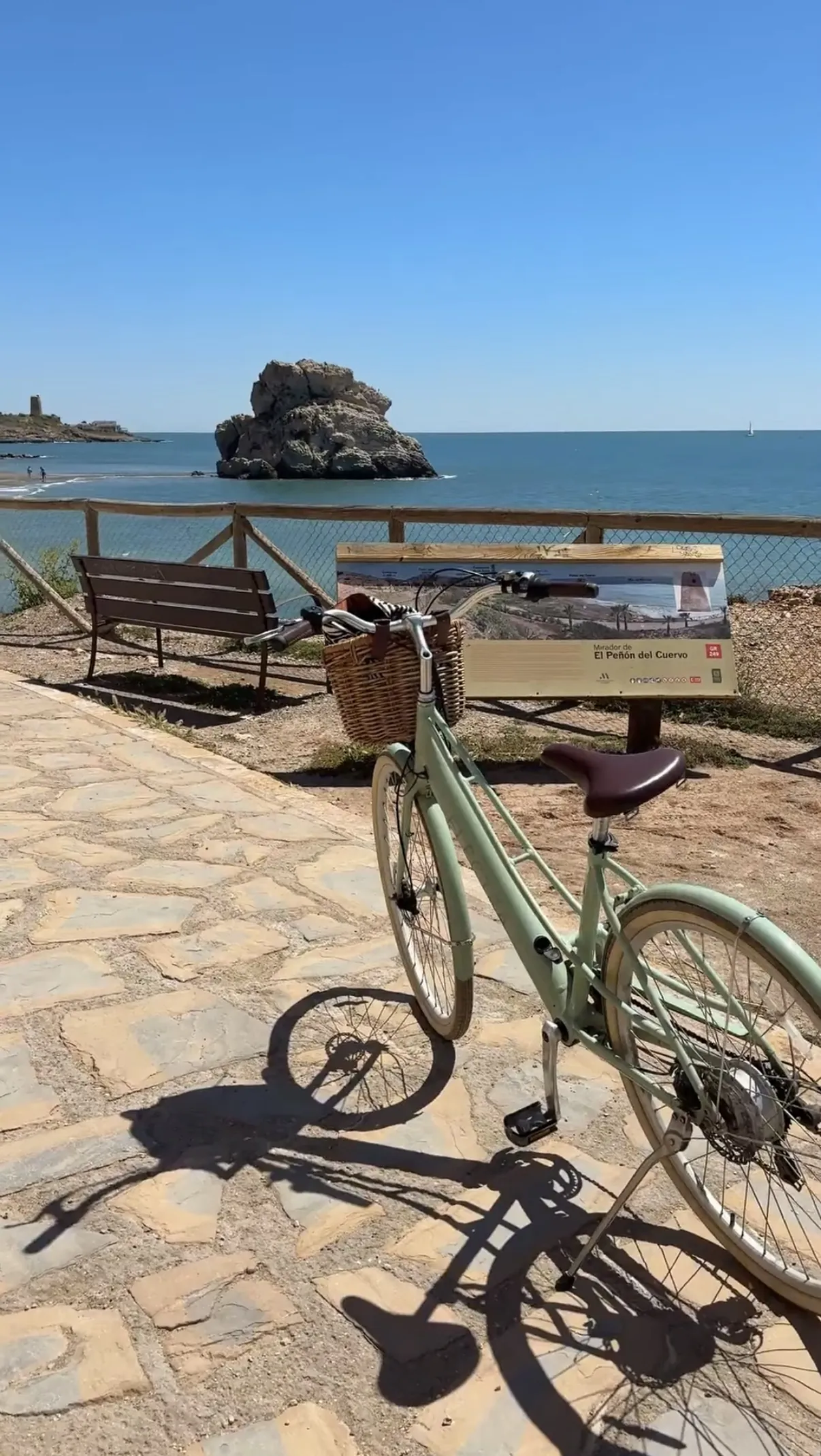 My rental bike parked at the El Peñón del Cuervo viewpoint, with the rock out in the sea