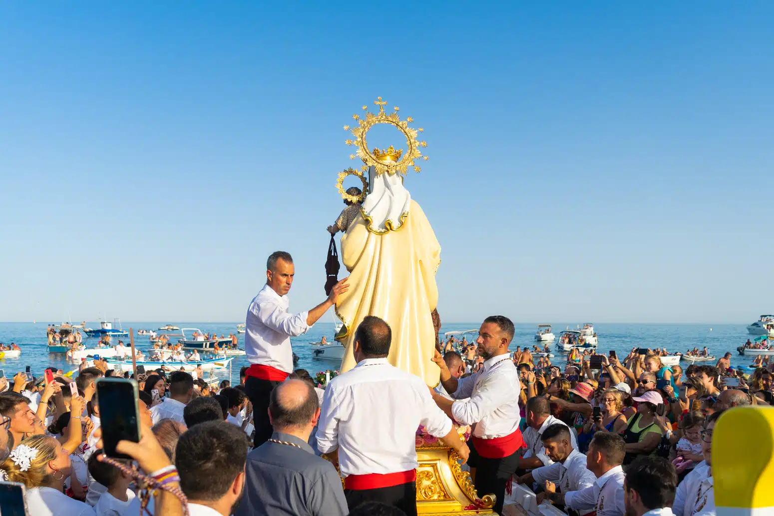 Virgen del Carmen carried out to sea on a decorated boat during the July procession in Malaga