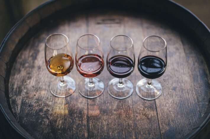 Flight of local Málaga wines lined up on a barrel