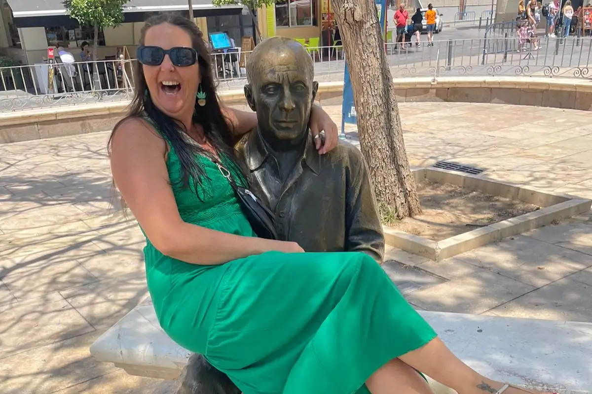 Picasso statue in Plaza de la Merced surrounded by tourists in Malaga
