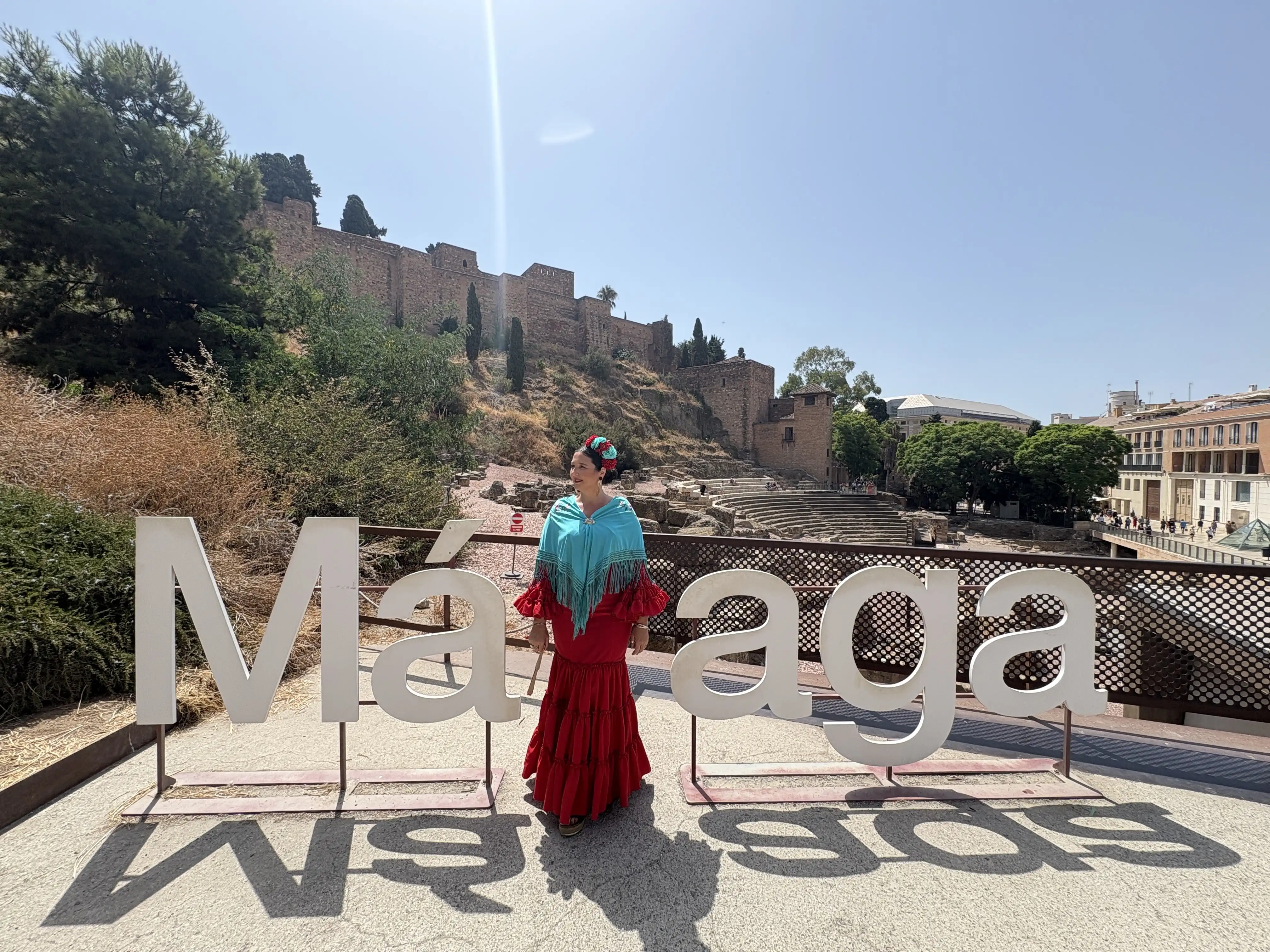 Heidi posing in front of the Malaga sign near the Roman Theatre