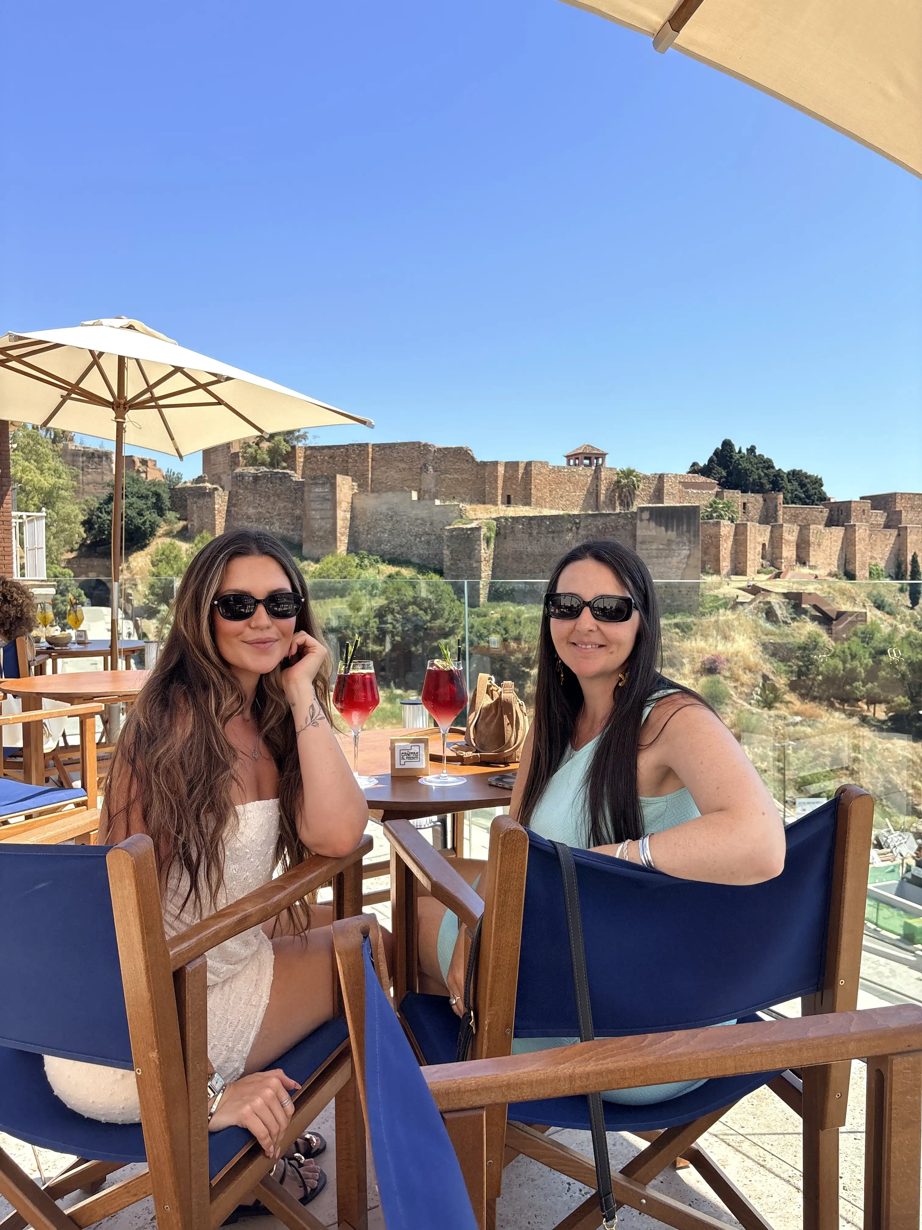 Woman enjoying the panoramic view from a rooftop terrace over Málaga