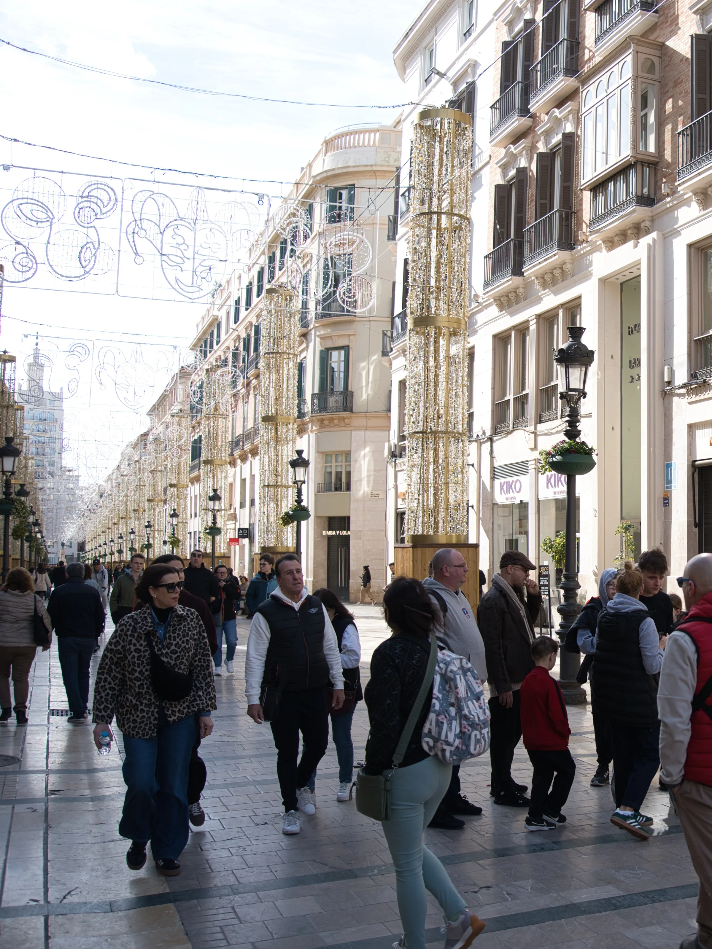 People walking down Calle Larios in Malaga with Christmas decorations
