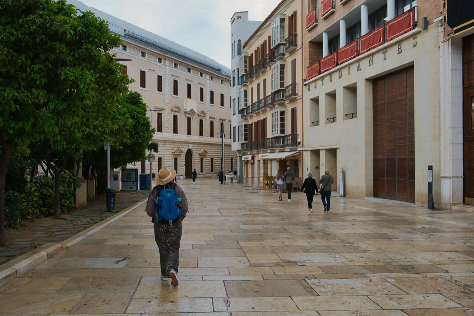 Heidi walking through an old town square in Malaga