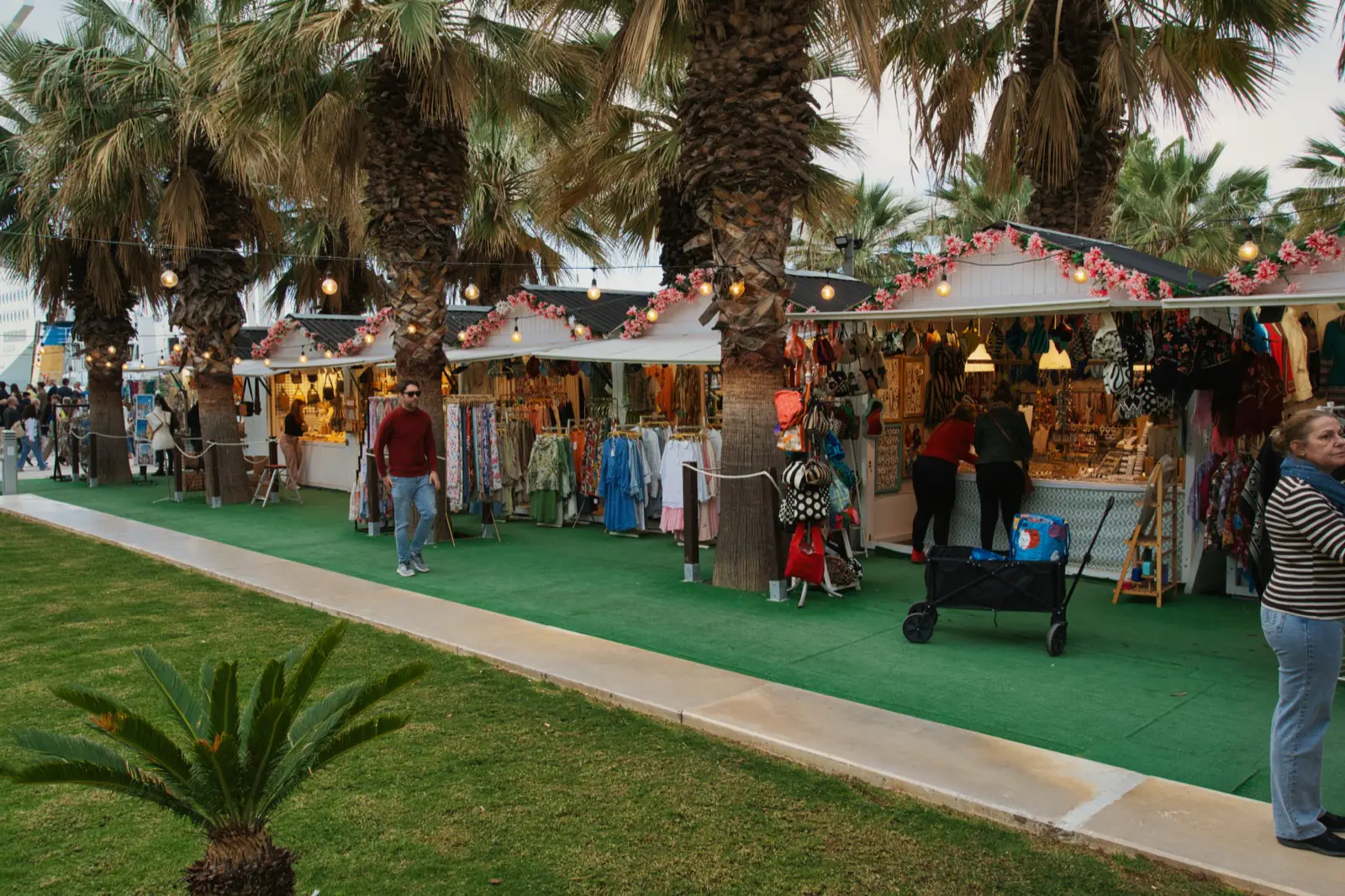 Evening market stalls and shoppers in central Malaga