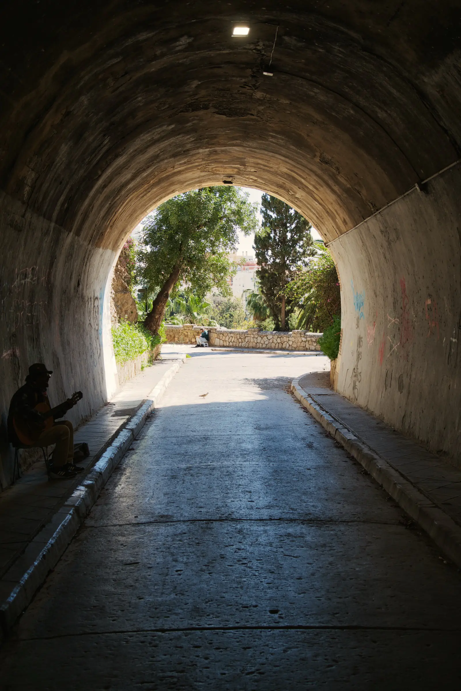 Guitarist playing in a pedestrian tunnel in Malaga